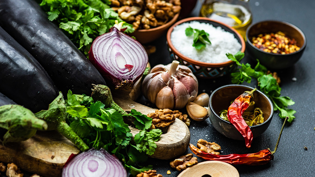 Ingredients for cooking eggplant with nut pasta on rustic background